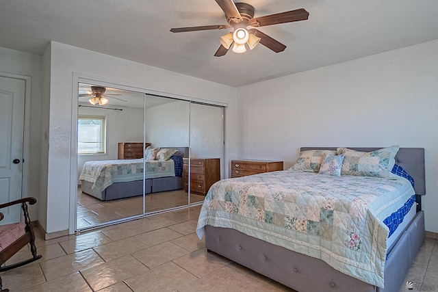 tiled bedroom featuring a closet and ceiling fan