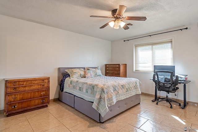 bedroom featuring light tile patterned flooring, baseboards, a textured ceiling, and ceiling fan