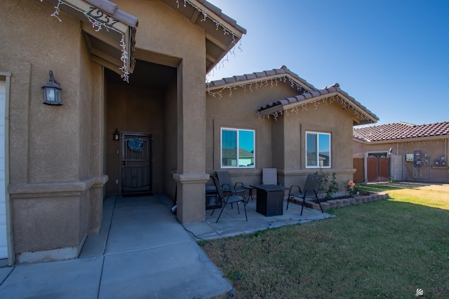 back of property with a patio and a yard