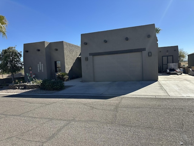 pueblo-style house with a garage