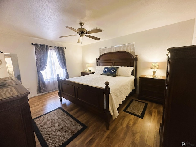 bedroom featuring ceiling fan, a textured ceiling, and wood finished floors