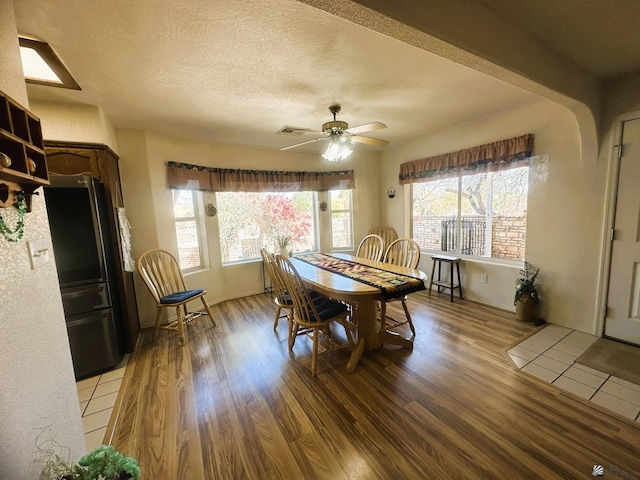 dining space featuring a wealth of natural light, visible vents, and light wood-style flooring