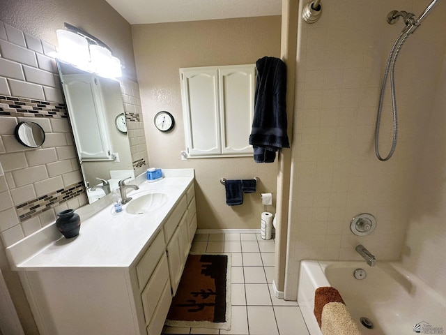 bathroom with tasteful backsplash, baseboards, tile patterned floors, bathtub / shower combination, and vanity