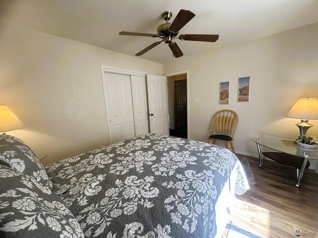 bedroom featuring ceiling fan, a closet, wood finished floors, and baseboards