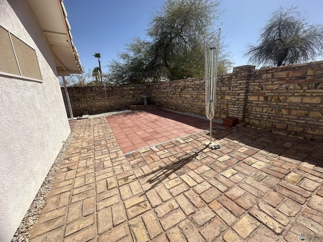 view of patio featuring fence