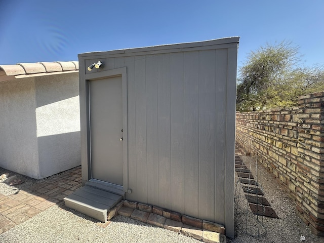 view of shed with fence