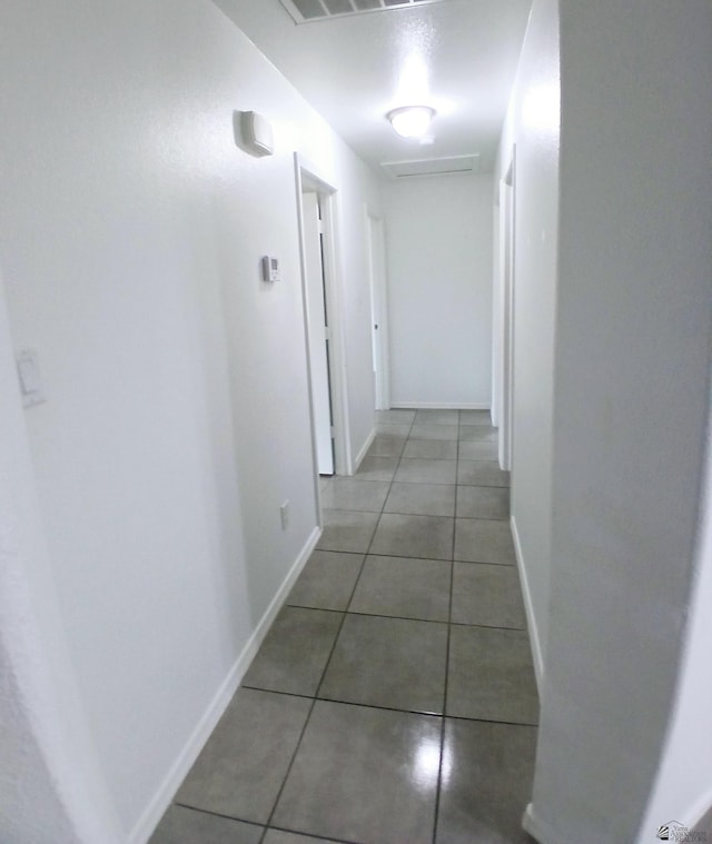 hall featuring dark tile patterned floors