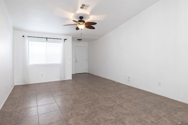 unfurnished room with ceiling fan, visible vents, and baseboards