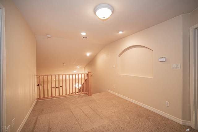 corridor with carpet flooring and vaulted ceiling