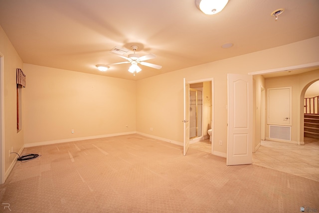 carpeted empty room featuring ceiling fan