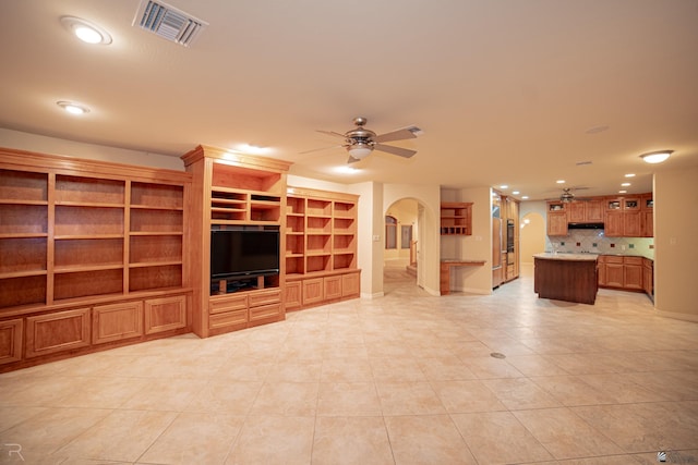 unfurnished living room with light tile patterned floors and ceiling fan