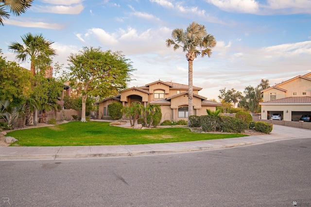 mediterranean / spanish home with a front yard