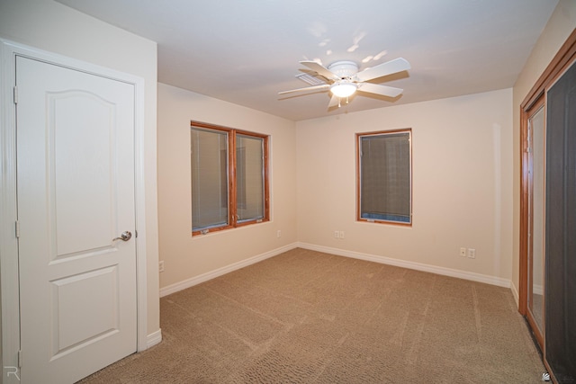 unfurnished bedroom with ceiling fan and carpet