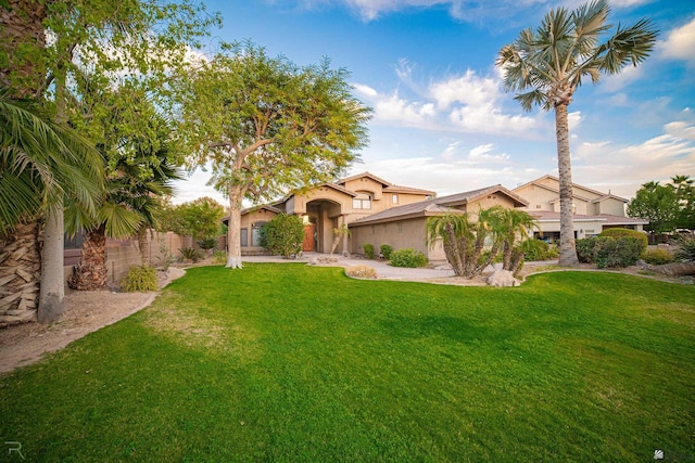 mediterranean / spanish-style house featuring a front yard