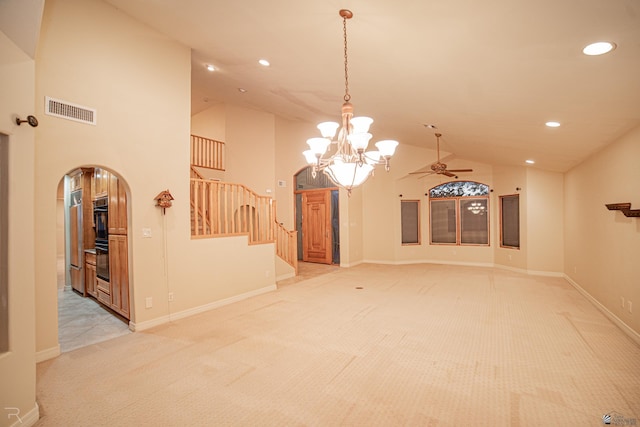 interior space featuring high vaulted ceiling and ceiling fan with notable chandelier