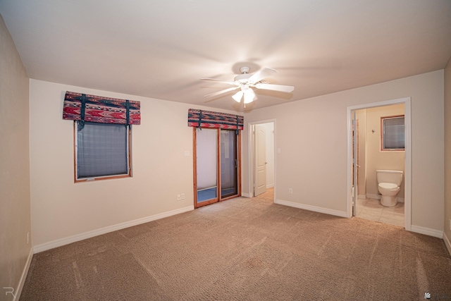 unfurnished bedroom with ensuite bathroom, carpet flooring, and ceiling fan