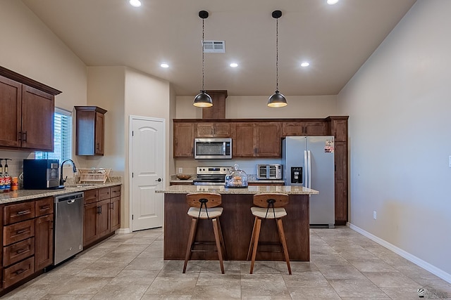 kitchen with sink, a center island, light stone counters, stainless steel appliances, and dark brown cabinets