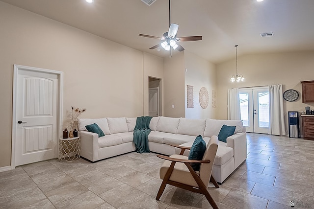 living room with ceiling fan with notable chandelier, high vaulted ceiling, and french doors