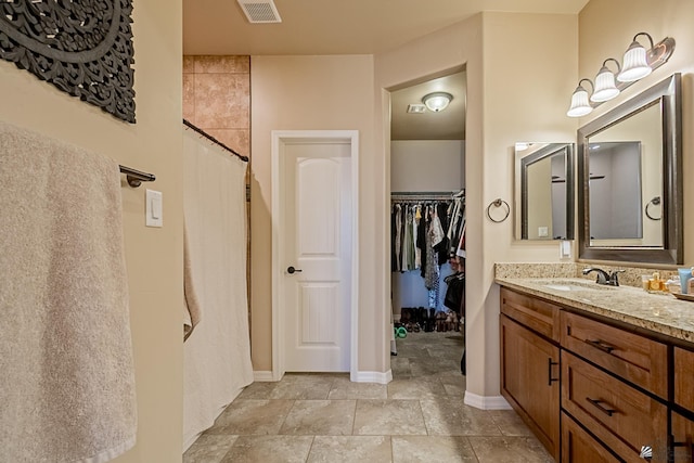 bathroom with walk in shower and vanity