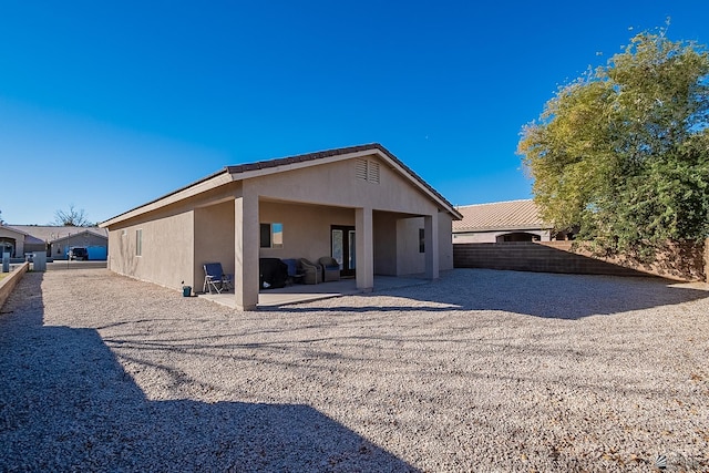 rear view of property featuring a patio area