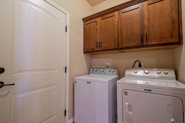 laundry room featuring cabinets and washer and dryer