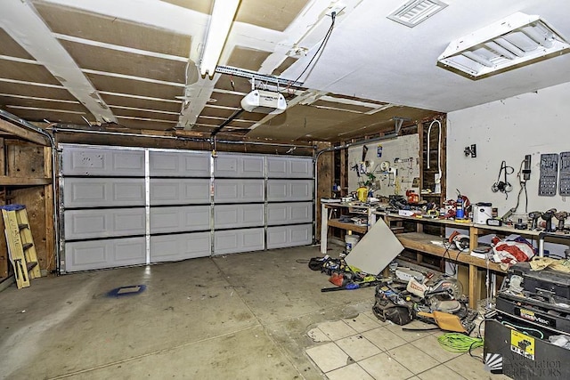 garage featuring a garage door opener and a workshop area