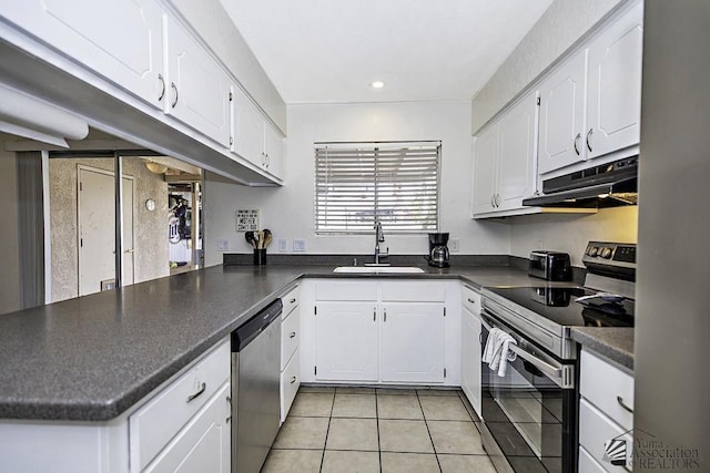 kitchen with stainless steel appliances, white cabinetry, and kitchen peninsula