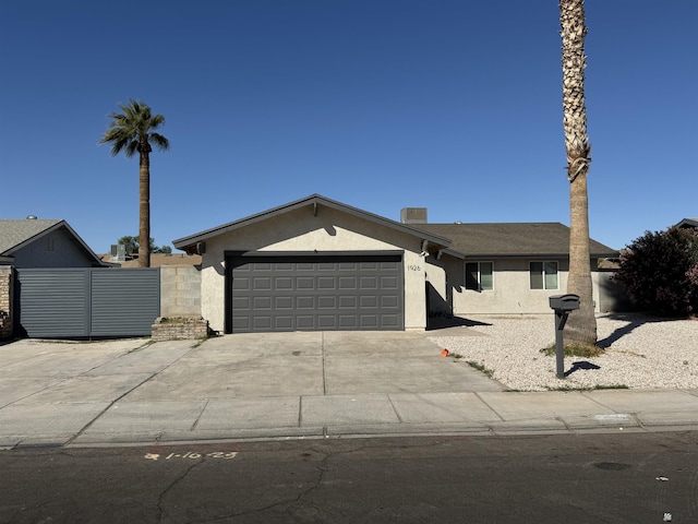 single story home featuring stucco siding, central AC, concrete driveway, and an attached garage