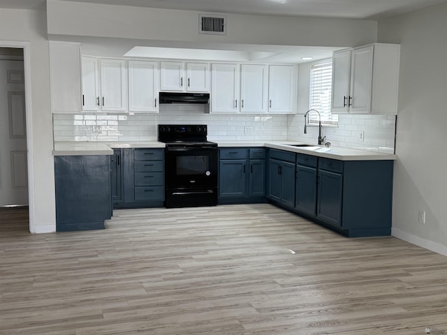 kitchen with visible vents, under cabinet range hood, white cabinets, black electric range oven, and a sink