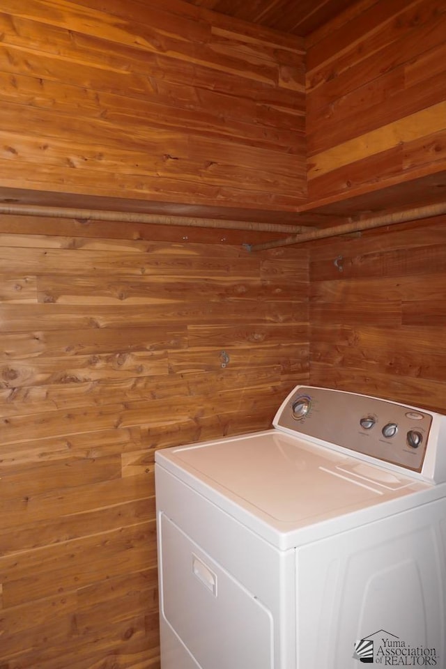 laundry room with washer / clothes dryer, wooden walls, and laundry area