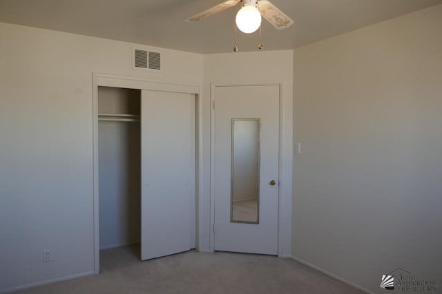 unfurnished bedroom with visible vents, light carpet, a closet, and a ceiling fan