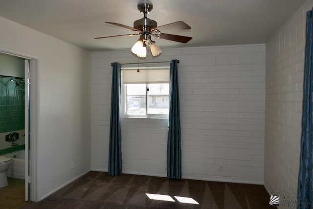 spare room featuring a ceiling fan and carpet flooring