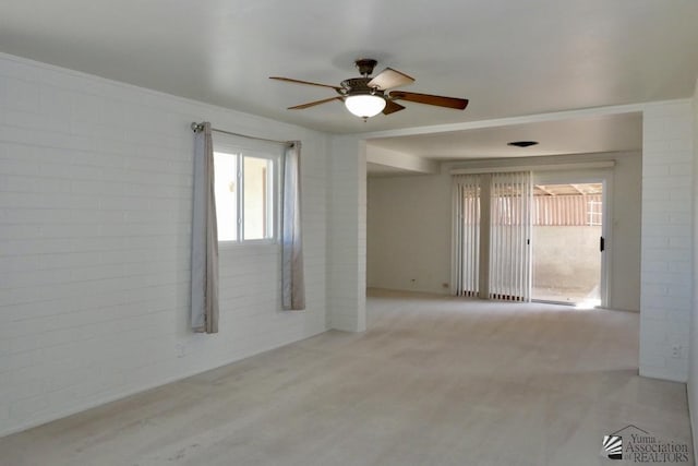 empty room with brick wall and a ceiling fan