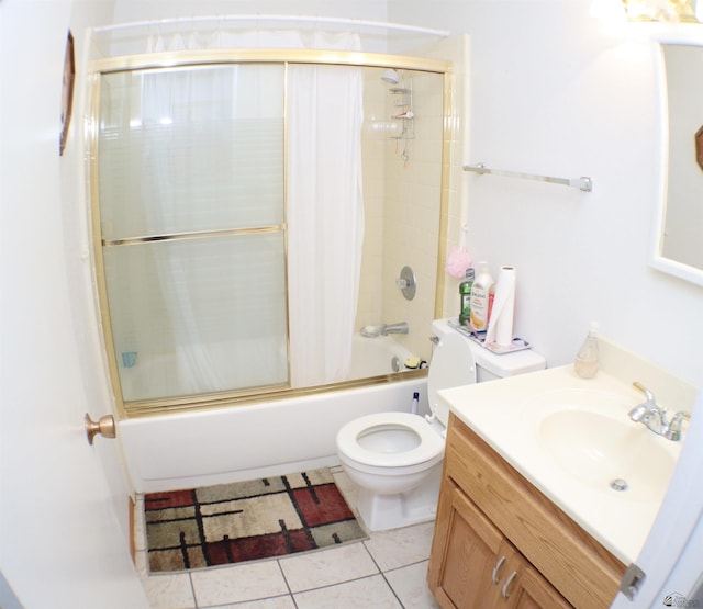 full bathroom featuring tile patterned flooring, vanity, toilet, and shower / bath combination with glass door