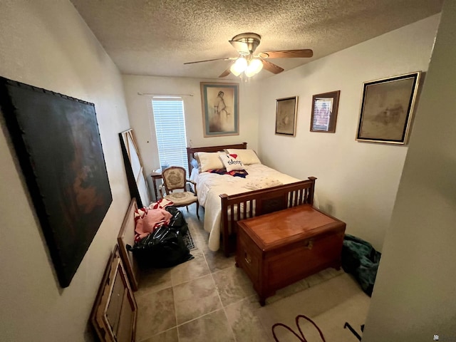 bedroom with ceiling fan and a textured ceiling