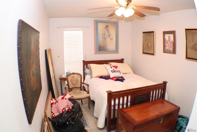 bedroom with ceiling fan and light tile patterned floors