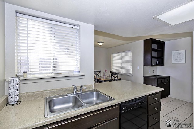 kitchen with black dishwasher, light countertops, a sink, and dark brown cabinetry