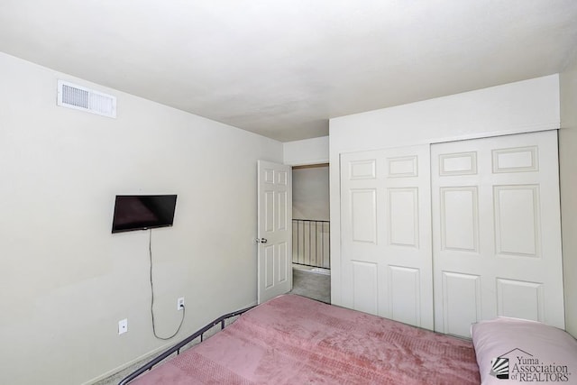 bedroom featuring carpet, visible vents, and a closet