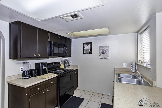 kitchen featuring black appliances, a sink, and light countertops