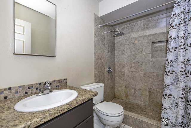 bathroom with toilet, a shower stall, and vanity