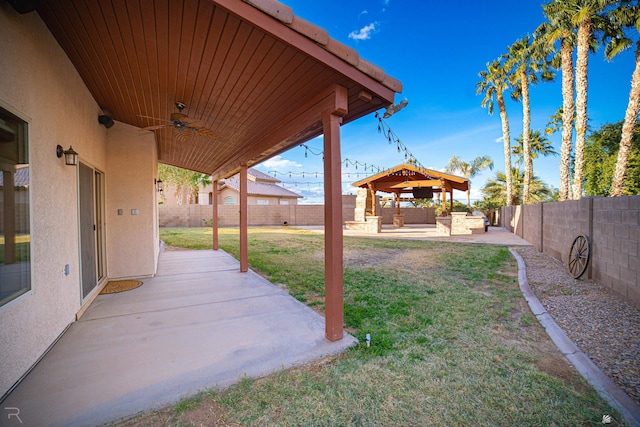 view of yard with a gazebo, a patio area, and ceiling fan