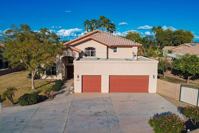 mediterranean / spanish house featuring a garage and a front lawn