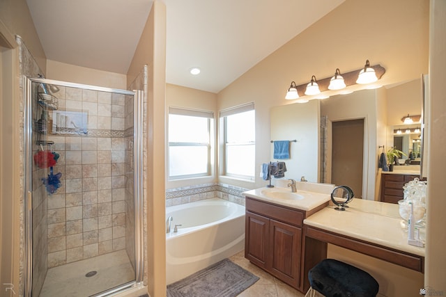 bathroom with tile patterned floors, separate shower and tub, vaulted ceiling, and vanity