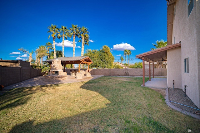 view of yard featuring a gazebo, a multi sided fireplace, and a patio