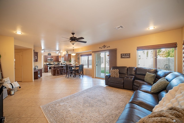 living room with light tile patterned floors and ceiling fan