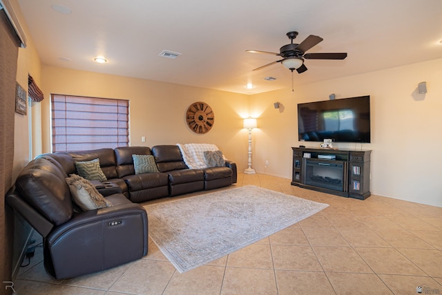 living room with ceiling fan, light tile patterned floors, and a fireplace