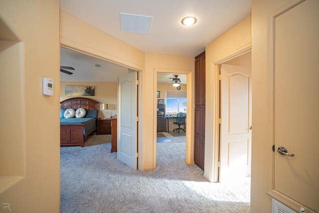 hall with light colored carpet