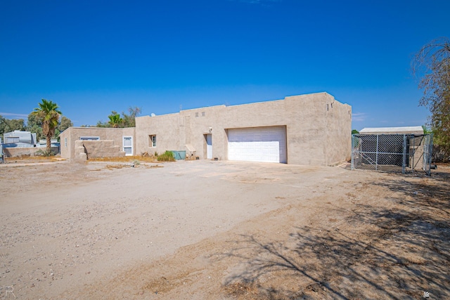 pueblo-style home with a garage