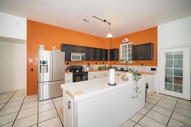 kitchen featuring stainless steel fridge with ice dispenser, black / electric stove, tile countertops, pendant lighting, and light tile patterned flooring