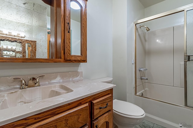 full bathroom with vanity, enclosed tub / shower combo, and toilet